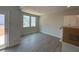 Bright living room with wood floors, large windows, and a doorway to the outdoor area at 285 Gregory Village Dr, Lillington, NC 27546