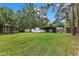 Expansive backyard featuring a shed, trailer parking, and carport surrounded by lush greenery and tall trees at 308 Deep Creek Dr, Clayton, NC 27520
