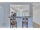 Open bar area with a view of the kitchen, pendant lights, and seating for two at 308 Deep Creek Dr, Clayton, NC 27520