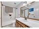 Bright bathroom with a tub, toilet, and vanity featuring wooden cabinets and a decorative mirror at 308 Deep Creek Dr, Clayton, NC 27520