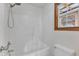 Bright bathroom featuring a modern shower-tub combo and window at 308 Deep Creek Dr, Clayton, NC 27520