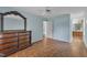 Light-filled bedroom featuring wood floors, dresser with mirror, and ensuite bathroom at 308 Deep Creek Dr, Clayton, NC 27520