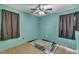 Bedroom with light blue walls, light wood floors, a ceiling fan, and a patterned rug at 308 Deep Creek Dr, Clayton, NC 27520