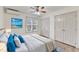 Well-lit bedroom with large bed, double door closet, ceiling fan and decorative window at 308 Deep Creek Dr, Clayton, NC 27520
