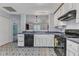 A stylish kitchen space featuring modern appliances and an open view into the living room at 308 Deep Creek Dr, Clayton, NC 27520