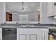 Traditional kitchen features white cabinets, stainless steel sink and appliances with a view to the living area at 308 Deep Creek Dr, Clayton, NC 27520