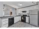 Cozy kitchen area featuring modern appliances, white cabinetry and tile flooring at 308 Deep Creek Dr, Clayton, NC 27520