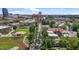 An aerial shot showcasing a property outlined in yellow, situated near a sports field and urban architecture at 311 N Gregson St, Durham, NC 27701