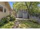 Backyard area with a small shed, fence, and lush landscaping featuring pink flowers at 311 N Gregson St, Durham, NC 27701