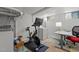 A basement space that includes an exercise bike, washer, dryer, desk, and a colorful rug at 311 N Gregson St, Durham, NC 27701
