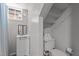 Small basement bathroom with white tile, vanity sink, toilet, window, and shower curtain at 311 N Gregson St, Durham, NC 27701