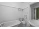 Bright bathroom featuring a classic clawfoot tub, a pedestal sink, and tiled floors at 311 N Gregson St, Durham, NC 27701
