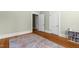 Neutral bedroom featuring hardwood floors, white trim, and a bookcase with colorful books at 311 N Gregson St, Durham, NC 27701