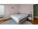 Light-filled bedroom with hardwood floors, a neutral color scheme, and minimalist decor at 311 N Gregson St, Durham, NC 27701