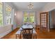 Charming dining room with hardwood floors, neutral paint, windows providing natural light, and an antique chandelier at 311 N Gregson St, Durham, NC 27701