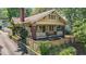 Charming yellow craftsman home with brick accents, a fenced yard, and a welcoming front porch at 311 N Gregson St, Durham, NC 27701