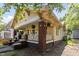 Charming yellow two-story home featuring a brick foundation and inviting front porch at 311 N Gregson St, Durham, NC 27701