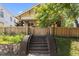 This house offers a well manicured lawn, mature landscaping, brick stairs, and secure fenced yard at 311 N Gregson St, Durham, NC 27701