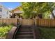Yellow craftsman home with a fenced yard, brick stairs, and a welcoming front porch at 311 N Gregson St, Durham, NC 27701