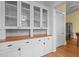 View of white cabinets and glass door shelving with butcher block countertops in a kitchen at 311 N Gregson St, Durham, NC 27701