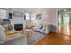 Living room showcasing a fireplace, hardwood floors, neutral walls, and access to other rooms at 311 N Gregson St, Durham, NC 27701