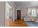 View of a living room with a front door, hardwood floors, and an adjacent room with multi-pane doors at 311 N Gregson St, Durham, NC 27701
