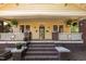 Charming yellow home with inviting covered porch, brick columns, potted plants, and a brick staircase at 311 N Gregson St, Durham, NC 27701