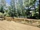 Wooden deck with railings overlooking the backyard and wooded area at 322 S Dixon Ave, Cary, NC 27511