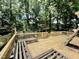 View of the spacious deck with built-in benches overlooking the wooded backyard at 322 S Dixon Ave, Cary, NC 27511