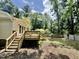 Wooden deck with railing overlooks large backyard with mature trees and privacy fence at 322 S Dixon Ave, Cary, NC 27511