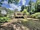 Wooden deck overlooks serene backyard with lush greenery and privacy fence at 322 S Dixon Ave, Cary, NC 27511