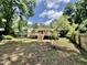 Exterior view of the backyard with deck, stairs, and mature trees at 322 S Dixon Ave, Cary, NC 27511