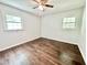 Bedroom featuring hardwood flooring, ceiling fan, and dual windows bringing in plenty of light at 322 S Dixon Ave, Cary, NC 27511
