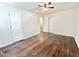 Comfortable bedroom offering hardwood floors, a ceiling fan, and ample closet space at 322 S Dixon Ave, Cary, NC 27511