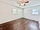 Spacious bedroom with dual windows and hardwood floors; ceiling fan included for maximum comfort at 322 S Dixon Ave, Cary, NC 27511