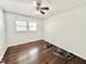 An empty bedroom with hardwood floors, a ceiling fan, and two windows at 322 S Dixon Ave, Cary, NC 27511