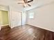 Bedroom featuring hardwood floors, ceiling fan, closet with sliding doors, and a window at 322 S Dixon Ave, Cary, NC 27511