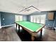 The game room features a pool table, hardwood floors, and French doors to the deck at 322 S Dixon Ave, Cary, NC 27511
