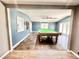 A large game room features a pool table, wood and tile floors, and ample room for entertaining at 322 S Dixon Ave, Cary, NC 27511