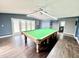 Large game room features a pool table, hardwood floors and French doors to the deck at 322 S Dixon Ave, Cary, NC 27511