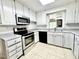 Modern kitchen boasts stainless steel appliances, white cabinets, and ample counter space at 322 S Dixon Ave, Cary, NC 27511