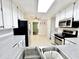 Updated kitchen features stainless steel appliances, tile floor, and backyard view at 322 S Dixon Ave, Cary, NC 27511