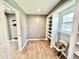 A laundry room is equipped with built-in shelving and tile floors for efficient organization at 322 S Dixon Ave, Cary, NC 27511
