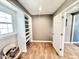 A laundry room is equipped with built-in shelving and tile floors for efficient organization at 322 S Dixon Ave, Cary, NC 27511