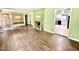 Open-concept living room with fireplace, hardwood floors, and access to kitchen at 322 S Dixon Ave, Cary, NC 27511