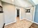 A spacious living room features tile floors, neutral paint, recessed lighting and a dartboard at 322 S Dixon Ave, Cary, NC 27511