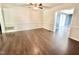 Living room with hardwood floors, ceiling fan, and open doorways at 322 S Dixon Ave, Cary, NC 27511