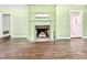 View of the living room showcasing a fireplace and hardwood flooring at 322 S Dixon Ave, Cary, NC 27511