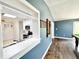 An open pass through provides a view of the kitchen and game room at 322 S Dixon Ave, Cary, NC 27511