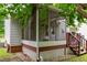 Screened-in back porch with wooden steps, perfect for enjoying the outdoors in comfort at 3405 E Jameson Rd, Raleigh, NC 27604